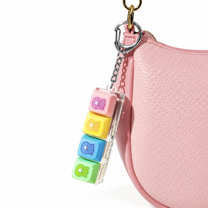 Care Bears fidget keychain attached to a pink handbag