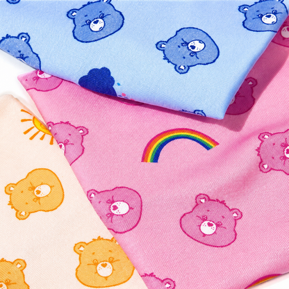 Close-up of Care Bears headband fabric patterns in blue, pink and yellow
